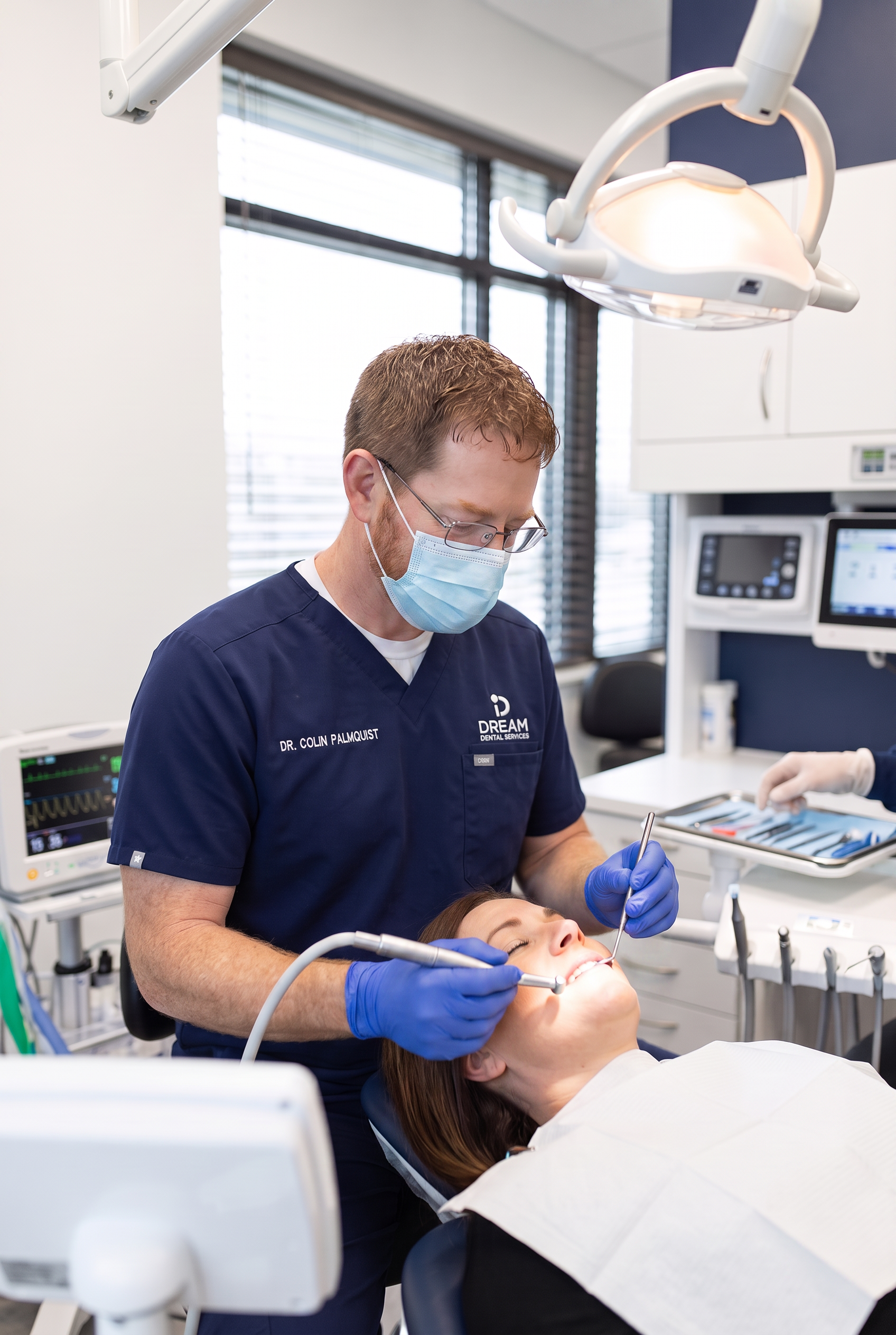 Dr. Colin Palmquist, dentist at Dream Dental Sedation in Watertown, SD, gently treating a relaxed patient in a modern dental operatory