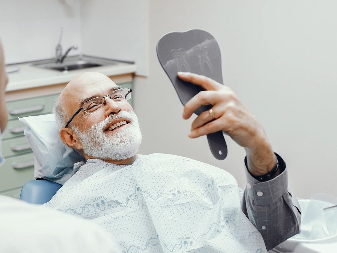 Dentist reviewing treatment options with an older patient at Dream Dental Sedation in Watertown, SD
